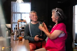 Older adults talking at a café counter (illustrative stock photograph)