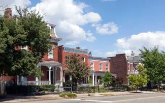 Brick homes and trees along a Richmond neighborhood street (illustrative stock photograph)
